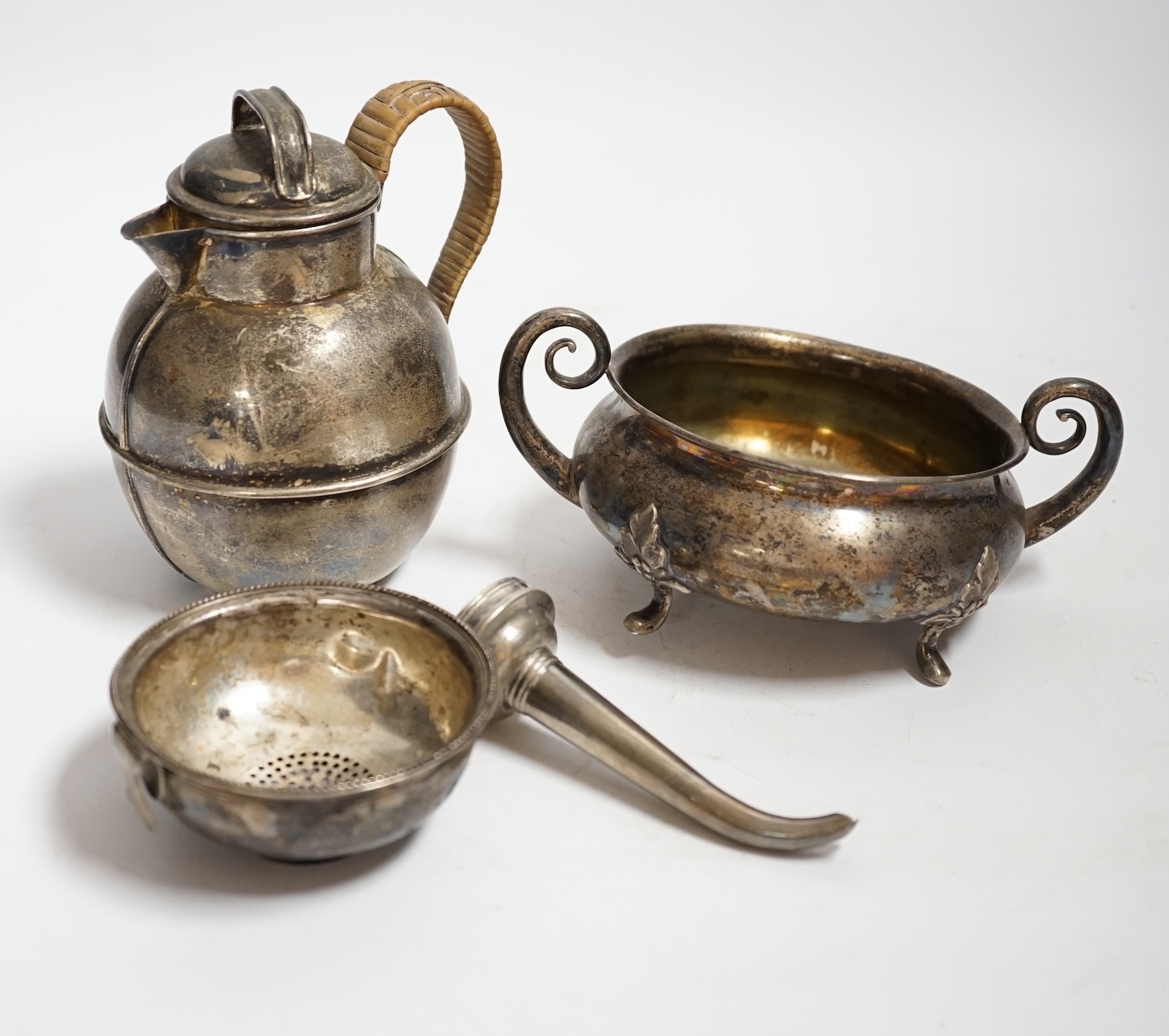 An Edwardian silver 'Guernsey' milk can, Mark Willis & Son, Sheffield, 1904, height 13cm, a George III silver wine funnel by Benjamin Montague? and a continental white metal two handle bowl (a.f.) gross weight 14.3oz.
